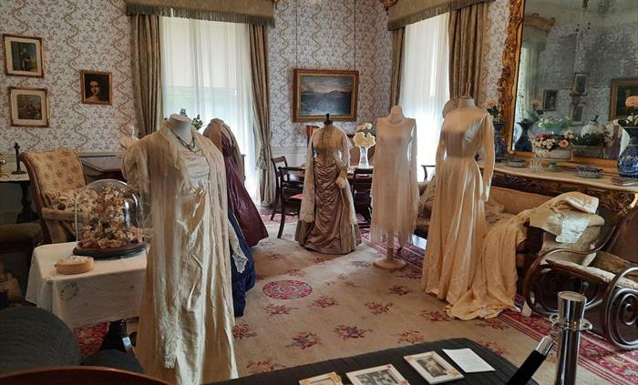 Display of period costumes in the drawing room at Scolton Manor